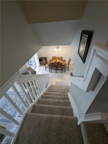 Stairs with carpet and baseboards
