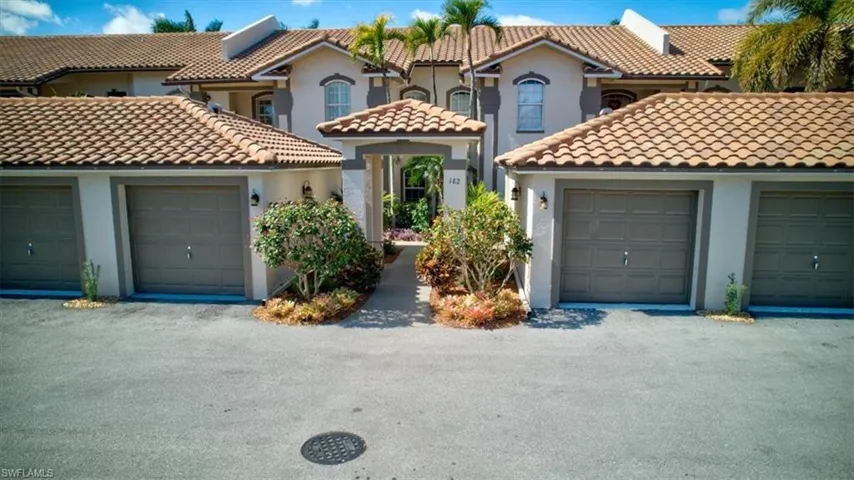 Mediterranean / spanish home with community garages and stucco siding