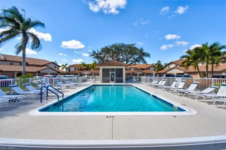 Community pool with a patio and a residential view