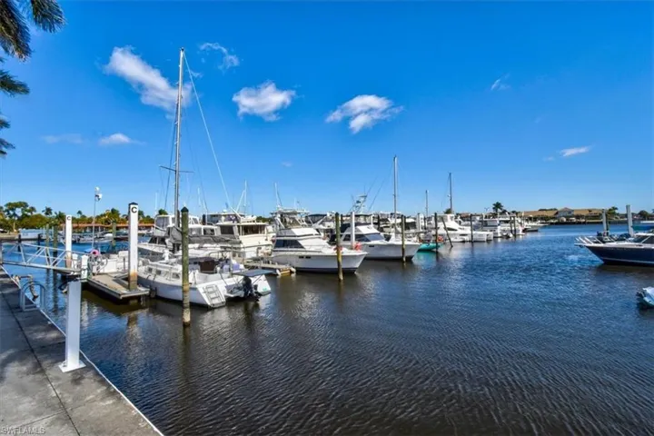 Dock area featuring a water view and view of marina