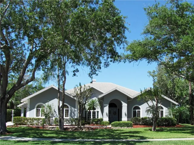 Ranch-style home with lush landscaping