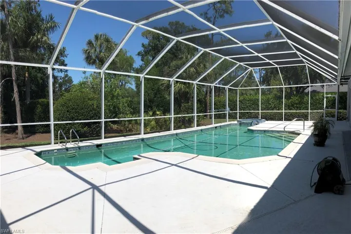 Swimming pool with a patio area and screen enclosure