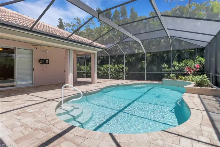 Pool with a lanai and a patio