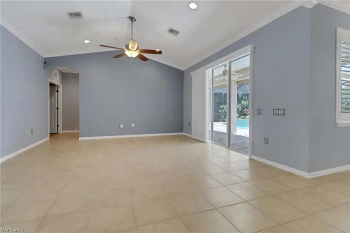 Unfurnished room with visible vents, ceiling fan, and crown molding