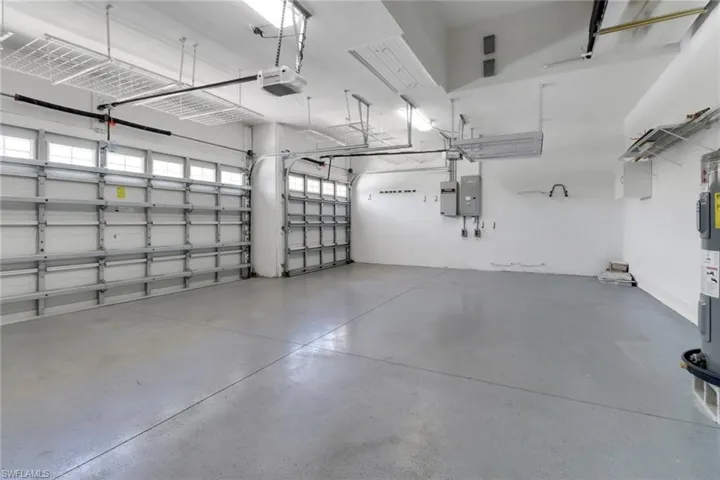 Garage featuring a garage door opener and electric panel