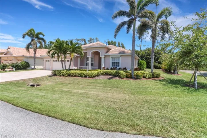 Mediterranean / spanish-style house with a front lawn, a tiled roof, driveway, a garage, and stucco siding