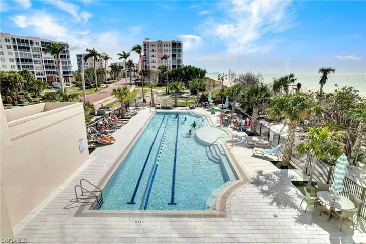 Pool with a patio and fence