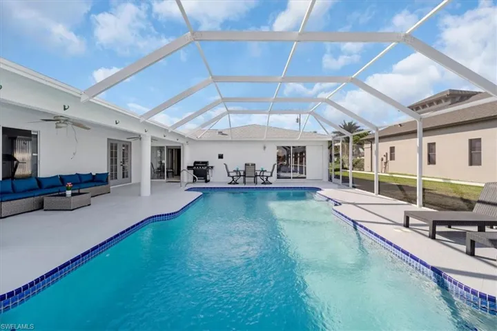 Outdoor pool with a ceiling fan, an outdoor hangout area, a sunroom, and a patio
