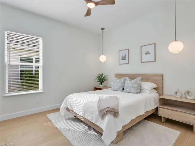 Bedroom with light wood-type flooring and a ceiling fan