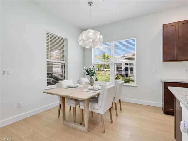 Dining area with light wood-style flooring and a chandelier