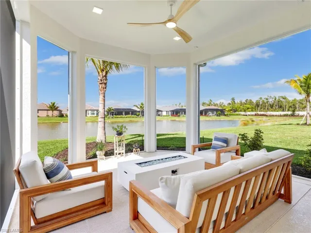 Sunroom featuring a water view and a residential view