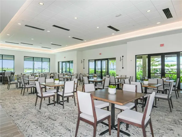 Dining area with recessed lighting and a raised ceiling