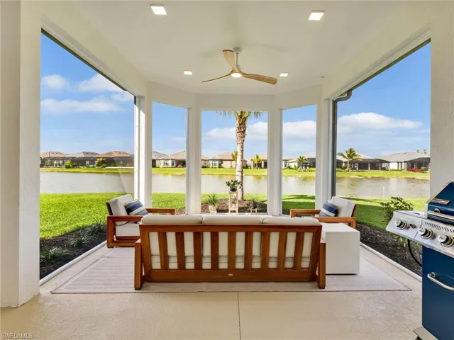 Sunroom featuring a residential view and a water view