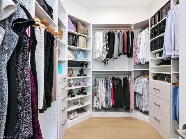 Spacious closet with light wood-style floors