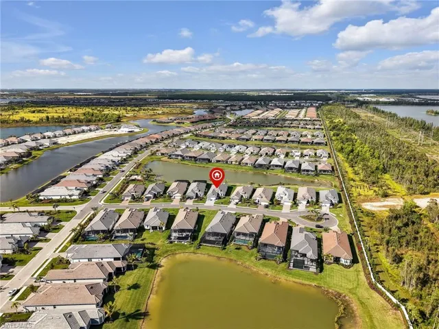 Aerial overview of property's location featuring nearby suburban area and a large body of water