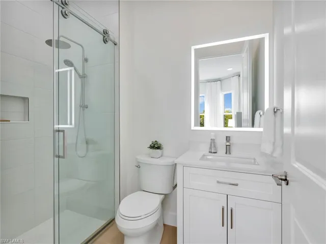 Full bathroom featuring vanity and a stall shower