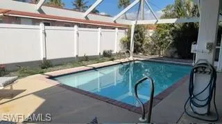 View of pool with a lanai and a patio area