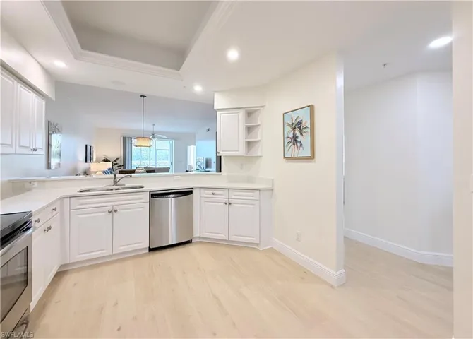 Large kitchen with white cabinets and quartz counter tops