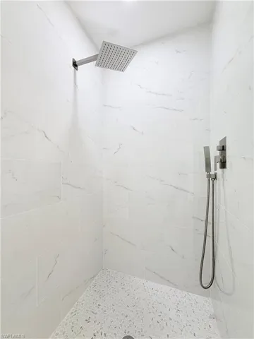 Floor to ceiling tile shower with penny time floors