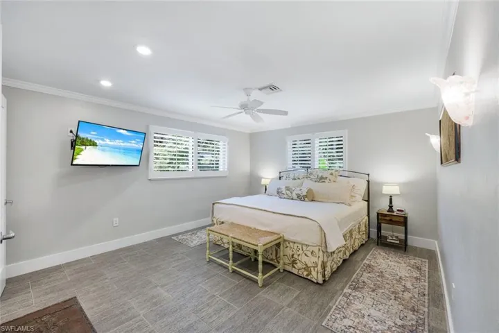 Bedroom with ornamental molding, baseboards, a ceiling fan, and recessed lighting