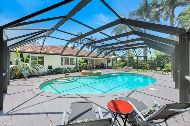 View of swimming pool featuring a patio and a pool with connected hot tub