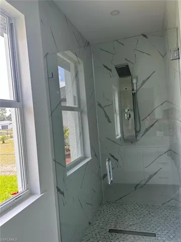 Bathroom with a shower with door