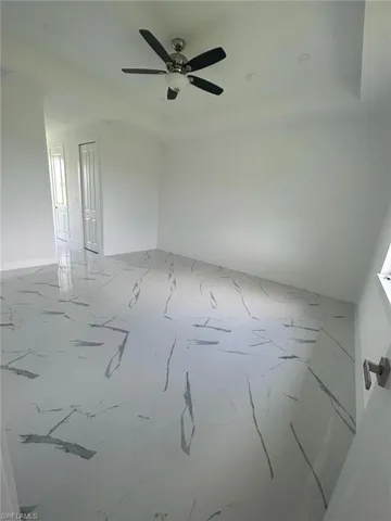 Unfurnished room featuring ceiling fan