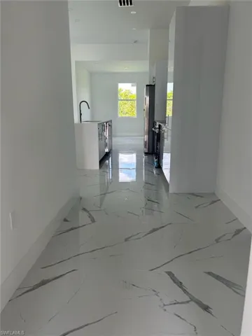 Hall with sink and tile floors