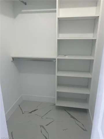 Walk in closet with tile floors