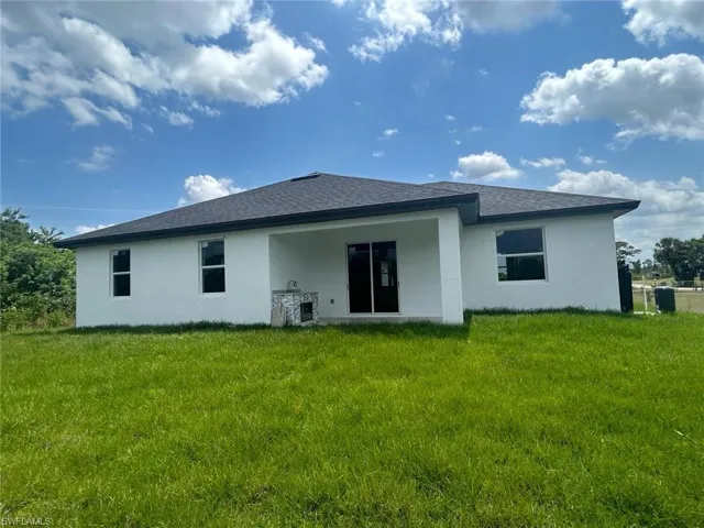Back of property with a yard