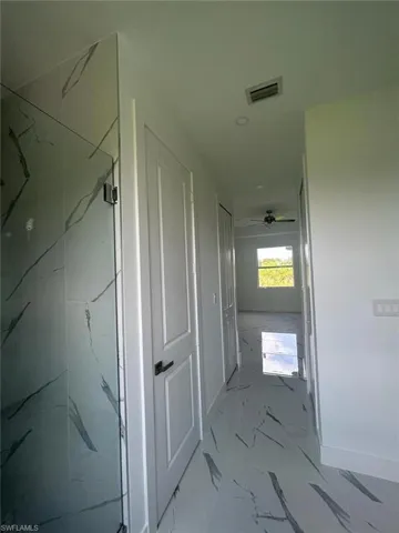 Hallway featuring tile floors