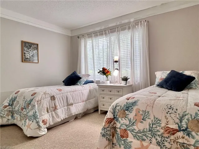 Guest Bedroom with carpet, crown molding and large window for lots of natural light.