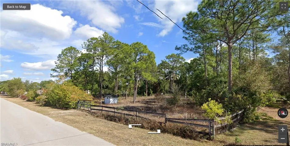 View of home's community with fence