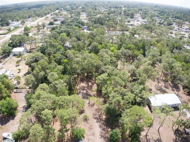 Birds eye view of property featuring a wooded view