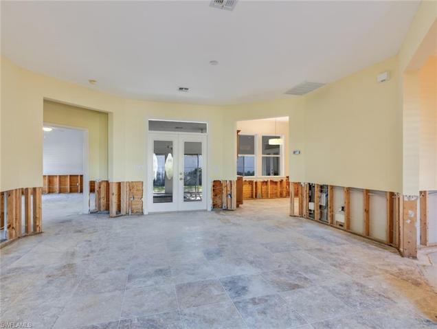 Living room to master bedroom on left, breakfast area on right. French doors to patio
