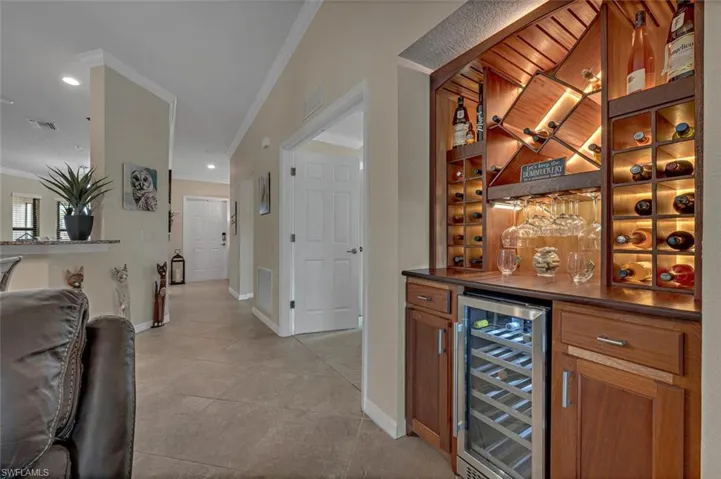 Elegant, one-of-a-kind custom mahogany wine bar illuminates and elevates the open concept living space