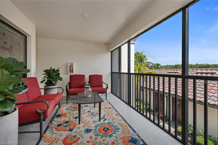 The screened-in front lanai offers breezy comfort in a relaxing outdoor oasis