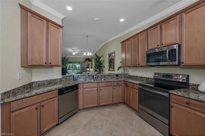 Expansive kitchen with abundant storage, complemented by a welcoming breakfast bar.