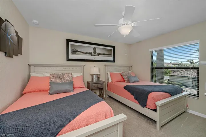 2 full-size beds in the guest bedroom with a walk-in closet