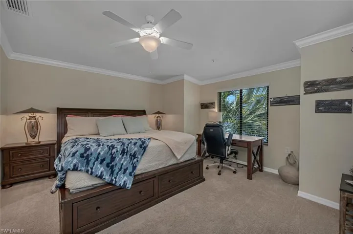 Luxurious primary suite with king bed at the back of the condo offers serene lake vistas and 2 walk-in closets