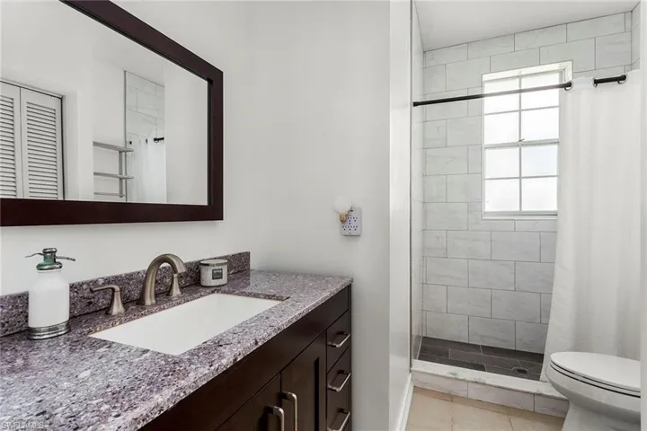 Bathroom featuring a shower stall and vanity