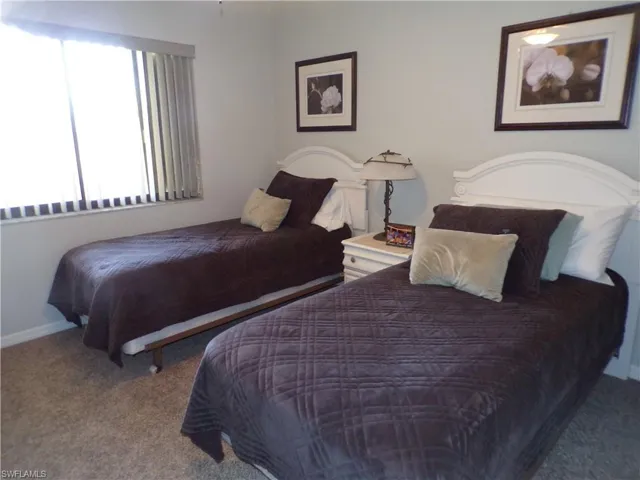 Carpeted bedroom featuring baseboards