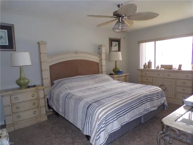 Carpeted bedroom with ceiling fan