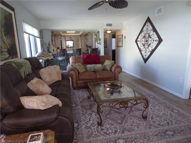 Living room featuring wood finished floors and ceiling fan