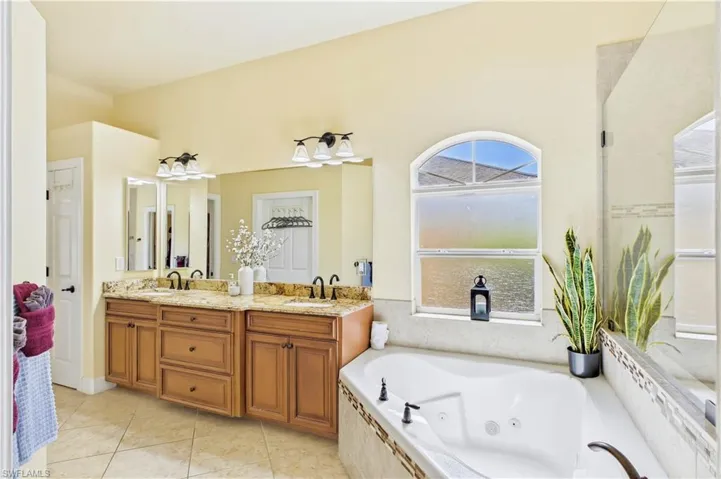 Arched windows and elevated ceilings fill the space with soft natural light and a bright airy ambiance.