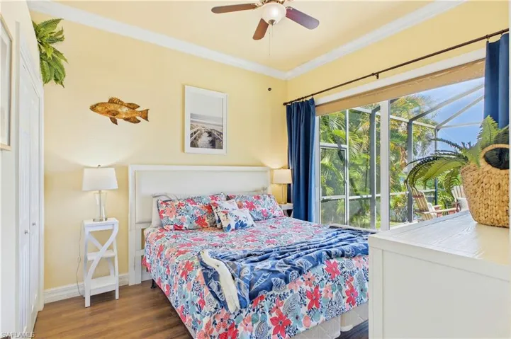 4th Guest Bedroom - Bright and inviting guest bedroom features vaulted ceilings, warm wood-look flooring & sliding glass doors with tranquil views of the tropical pool & spa area.
