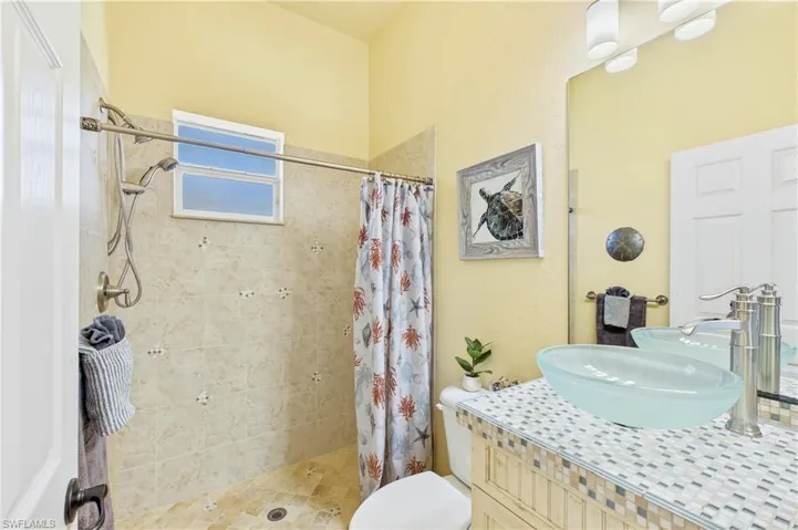 3rd Guest Bedroom - Beautifully updated guest bathroom features coastal-inspired finishes, walk-in shower & flexible layout with potential to create a private second primary-style suite.