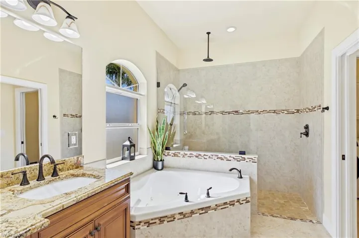 Relax and unwind in the luxurious soaking tub surrounded by abundant natural light and serene coastal-inspired finishes.