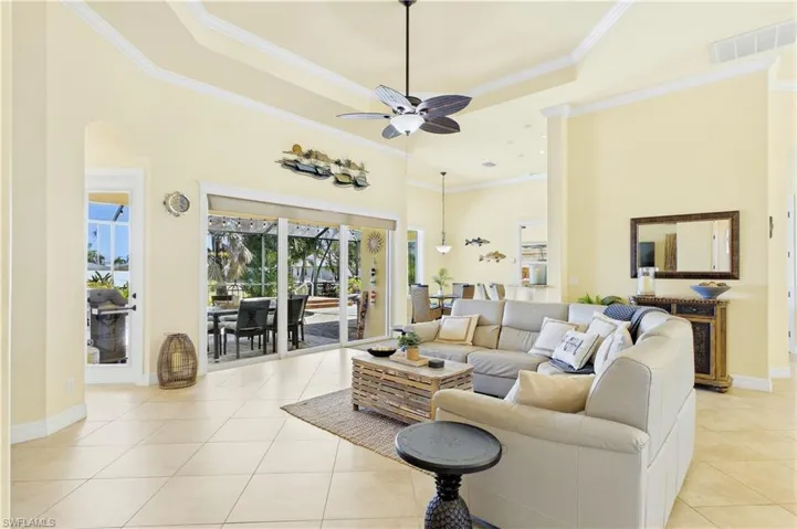 WARM COASTAL FINISHES, crown molding, upgraded lighting & EXPANSIVE WINDOWS showcasing beautiful tropical views!