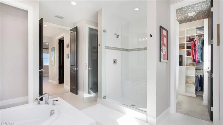 Bathroom featuring tile patterned flooring and independent shower and bath